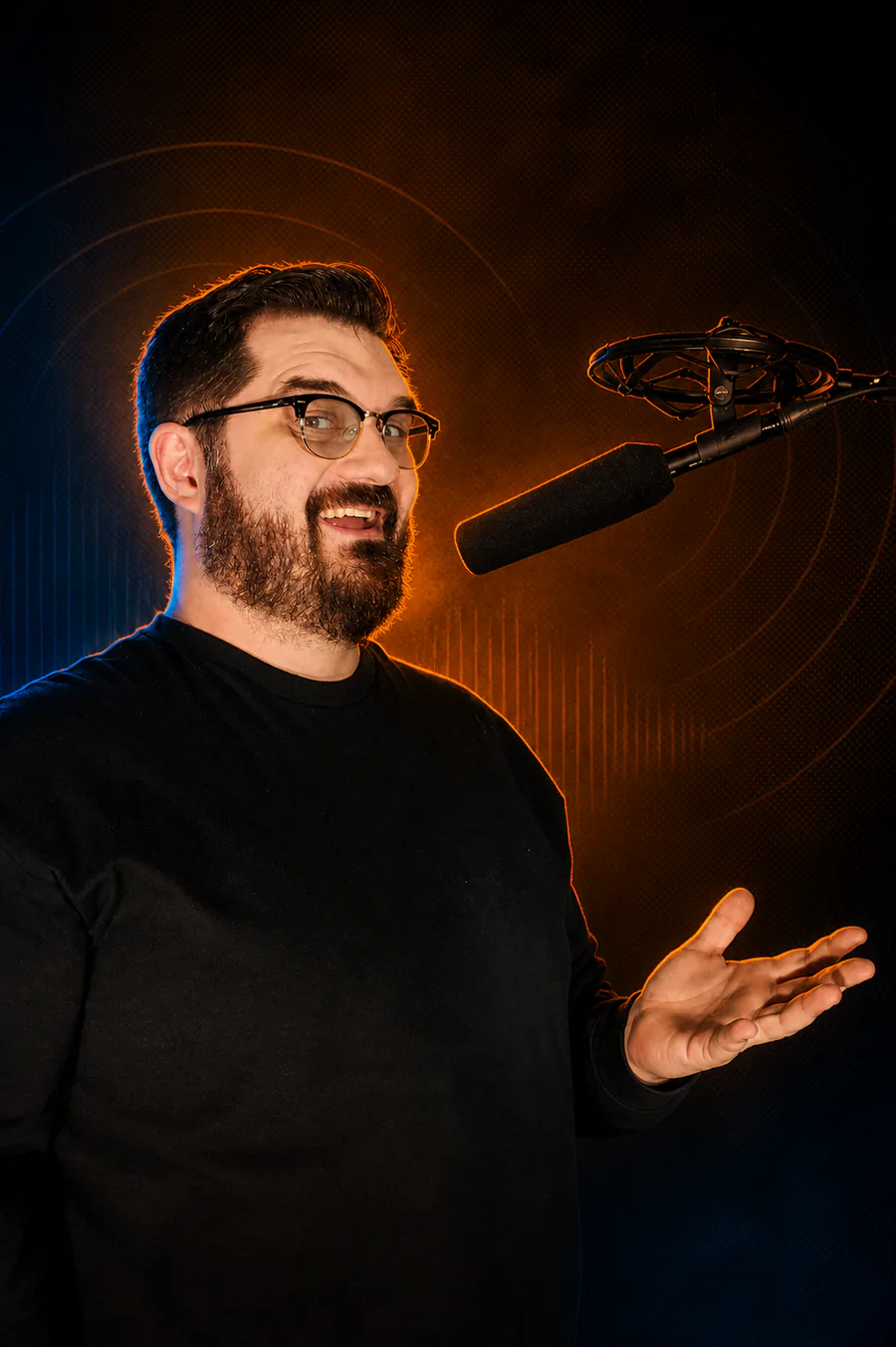 Glenn smiling and speaking into a studio microphone