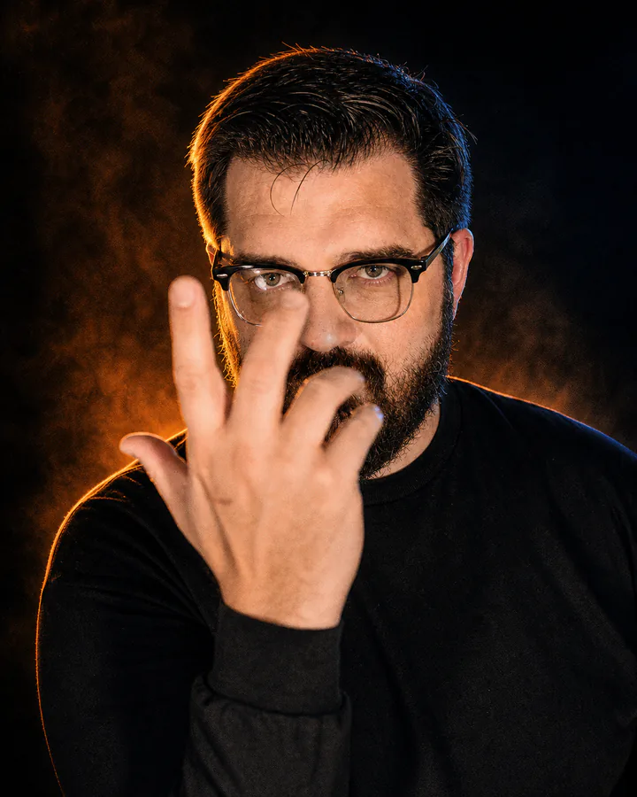 Glenn C. Hahn as The Storyteller in dramatic amber and blue light